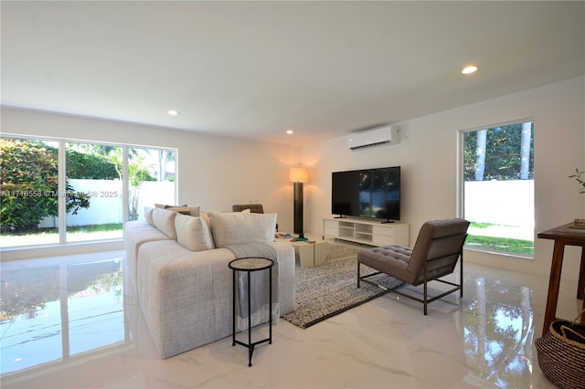 living room featuring a healthy amount of sunlight and a wall mounted AC