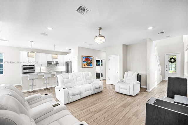 living room with light hardwood / wood-style flooring