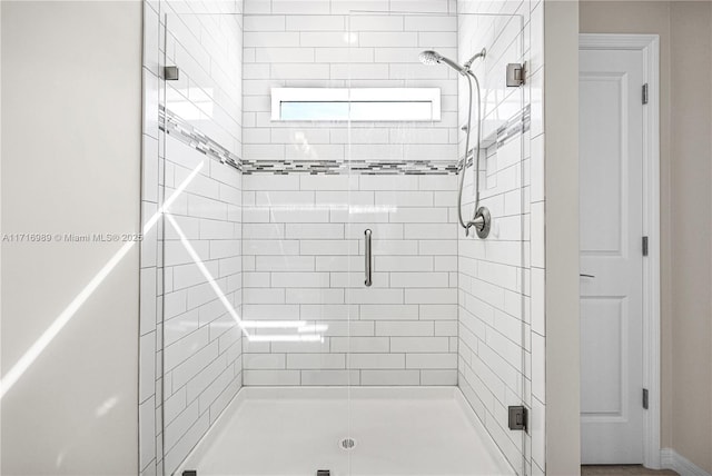 bathroom with a shower with shower door