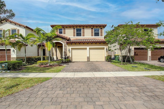 mediterranean / spanish-style house with a garage