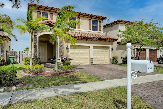 mediterranean / spanish-style home with a garage