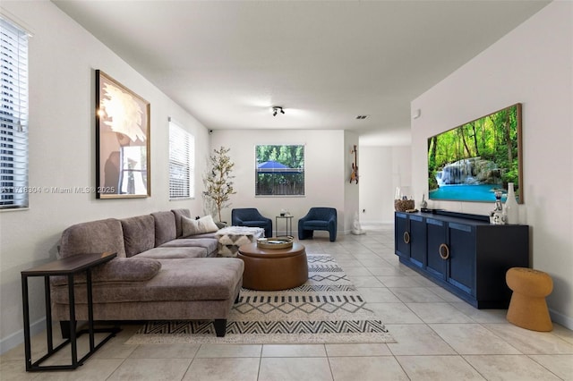 living room with a healthy amount of sunlight and light tile patterned floors