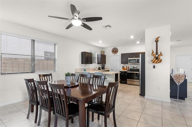 tiled dining room with ceiling fan