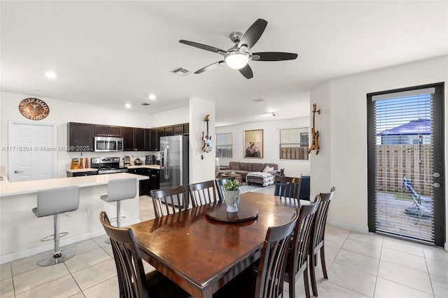 dining area featuring ceiling fan and light tile patterned floors