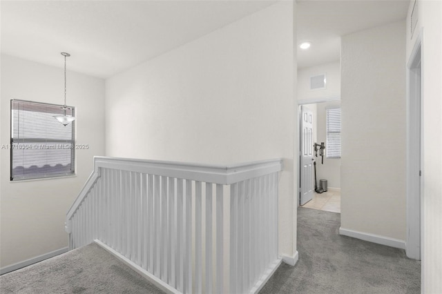 hallway with light colored carpet