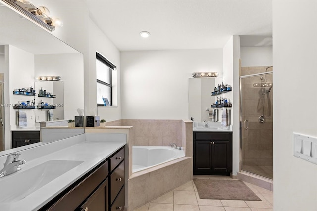 bathroom featuring plus walk in shower, vanity, and tile patterned floors