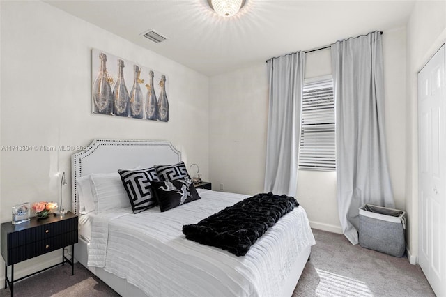 carpeted bedroom featuring a closet