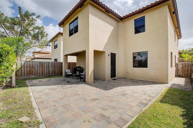 back of property featuring a patio