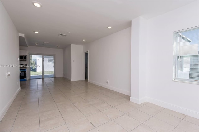 unfurnished room featuring light tile patterned flooring