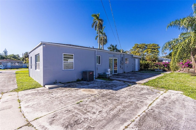 rear view of property with central air condition unit