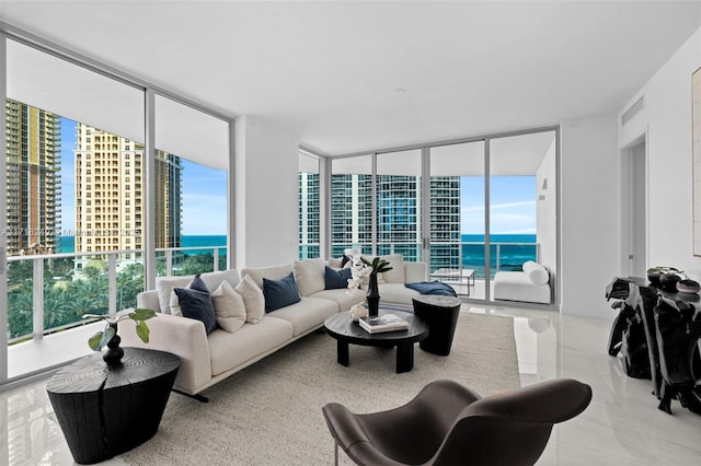 living room with a water view and a wall of windows