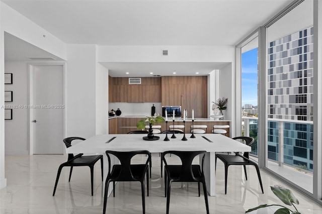 dining space featuring a wall of windows