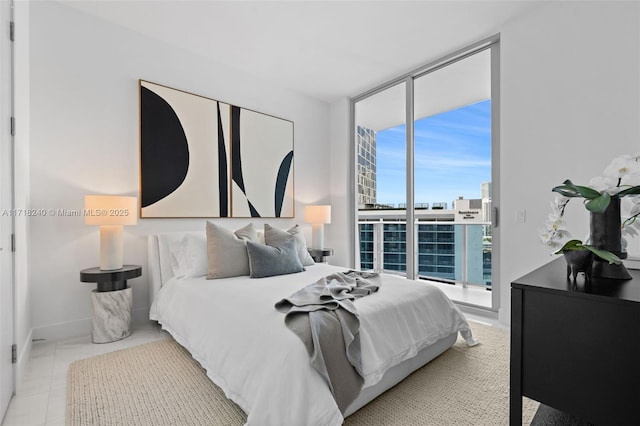 bedroom with access to exterior, expansive windows, and multiple windows