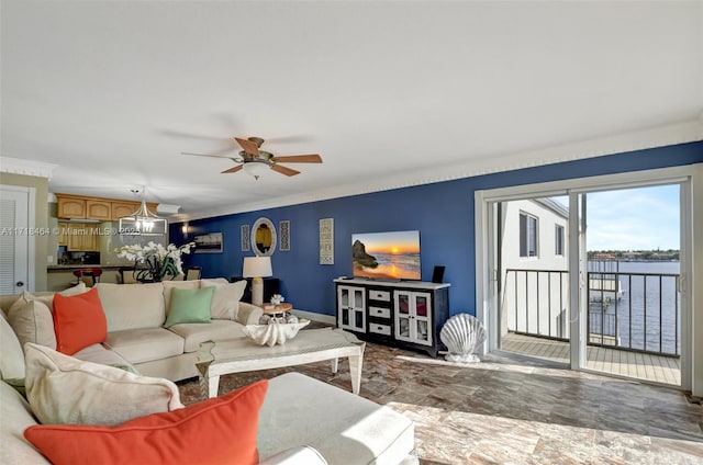 living room with ceiling fan and ornamental molding