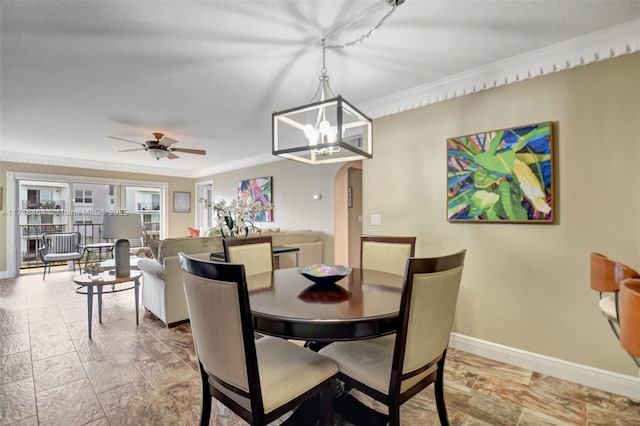 dining space with ceiling fan with notable chandelier and ornamental molding