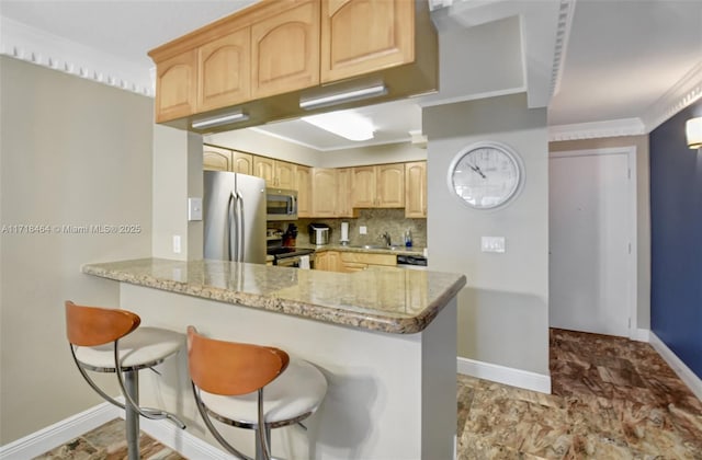 kitchen featuring light stone countertops, stainless steel appliances, kitchen peninsula, crown molding, and light brown cabinetry