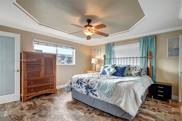 bedroom featuring multiple windows, ceiling fan, a textured ceiling, and ornamental molding