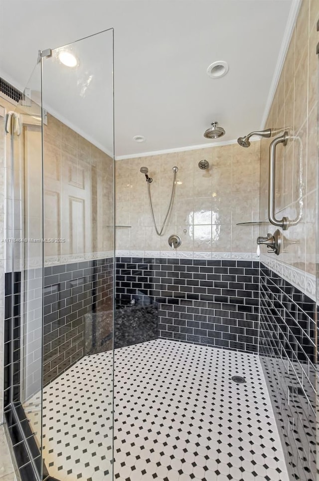 bathroom featuring tile patterned flooring, a shower with shower door, and crown molding