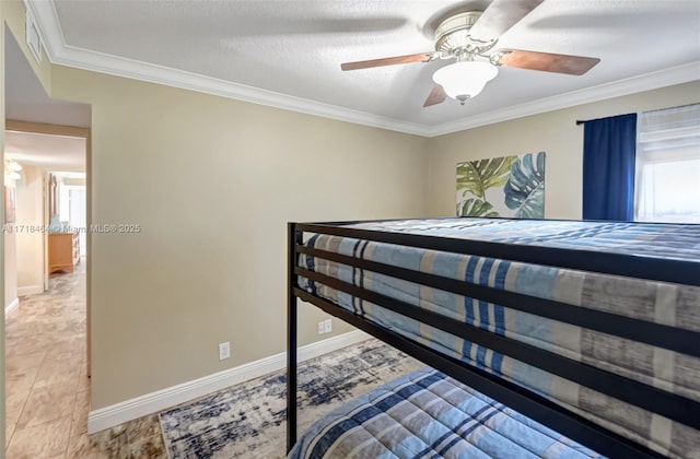 bedroom featuring ceiling fan, a textured ceiling, and ornamental molding