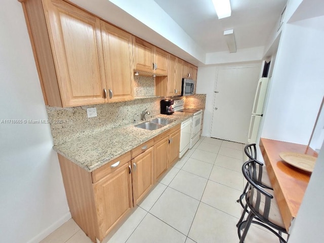 kitchen with dishwasher, sink, decorative backsplash, light stone countertops, and range