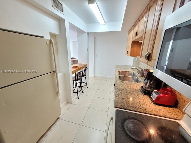 kitchen featuring white fridge and sink