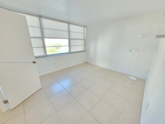 unfurnished room featuring light tile patterned flooring