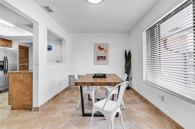 dining room featuring a textured ceiling