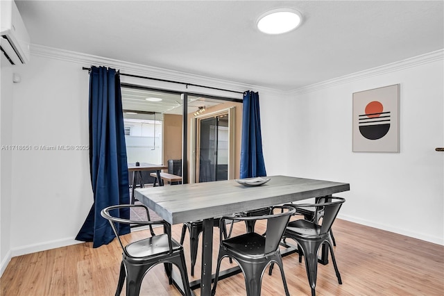 dining area with crown molding, light hardwood / wood-style floors, and a wall mounted AC