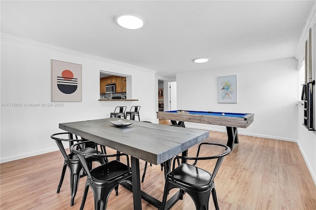 dining room with pool table, crown molding, and light hardwood / wood-style floors