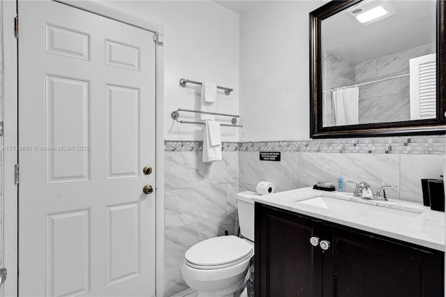 bathroom featuring vanity, tile walls, toilet, and a shower with shower curtain