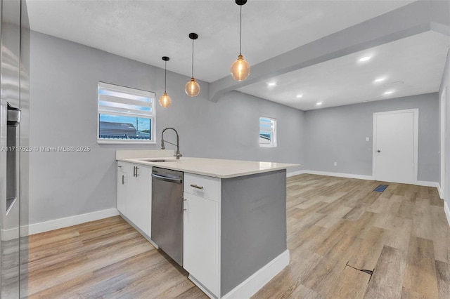 kitchen with sink, hanging light fixtures, stainless steel dishwasher, light hardwood / wood-style floors, and white cabinets