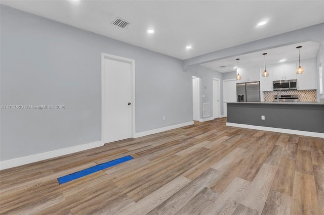 unfurnished living room with light hardwood / wood-style floors