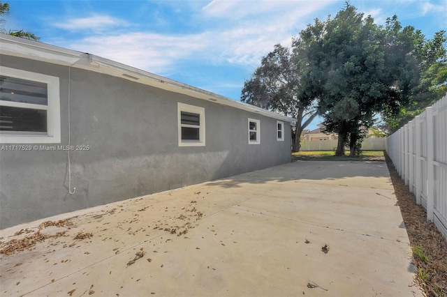 view of side of home featuring a patio area