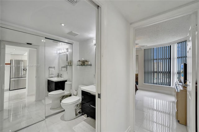 bathroom with vanity, toilet, and a bidet