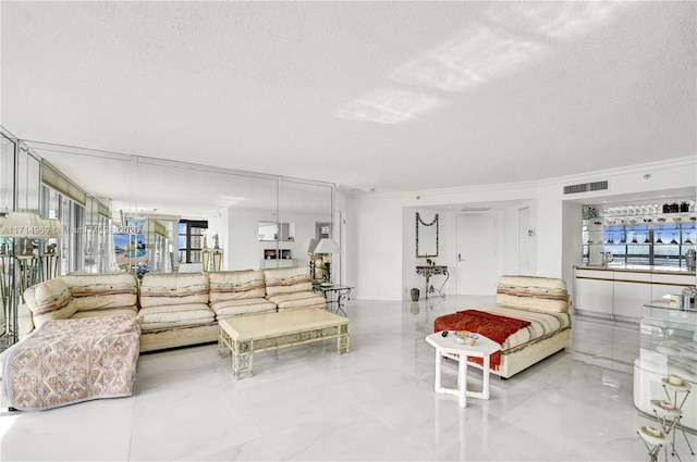 living room with crown molding and a textured ceiling