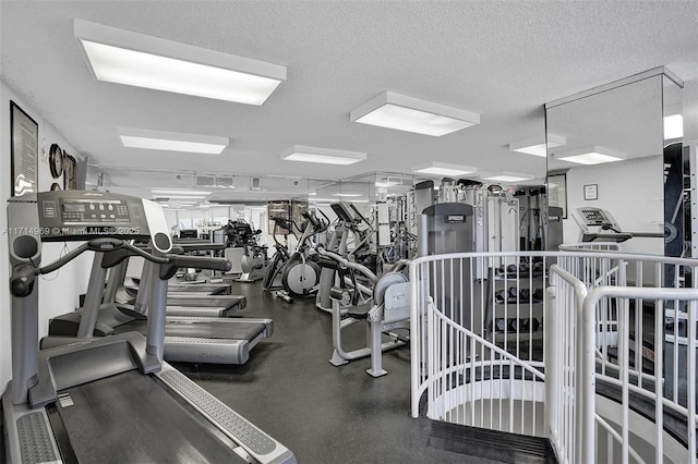 exercise room with a textured ceiling