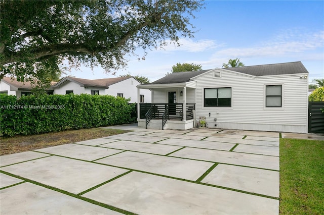 back of property featuring covered porch