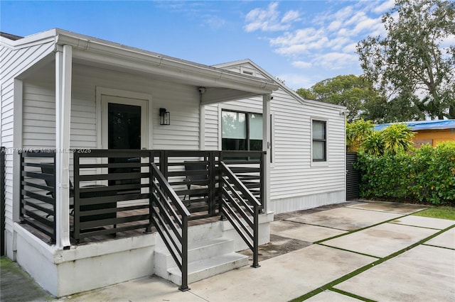 view of exterior entry with a porch