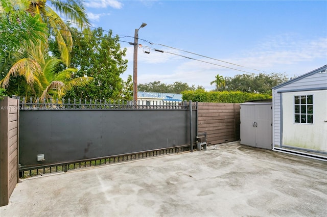 view of gate featuring a storage unit