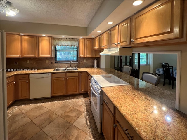 kitchen with electric range, sink, tasteful backsplash, white dishwasher, and a textured ceiling