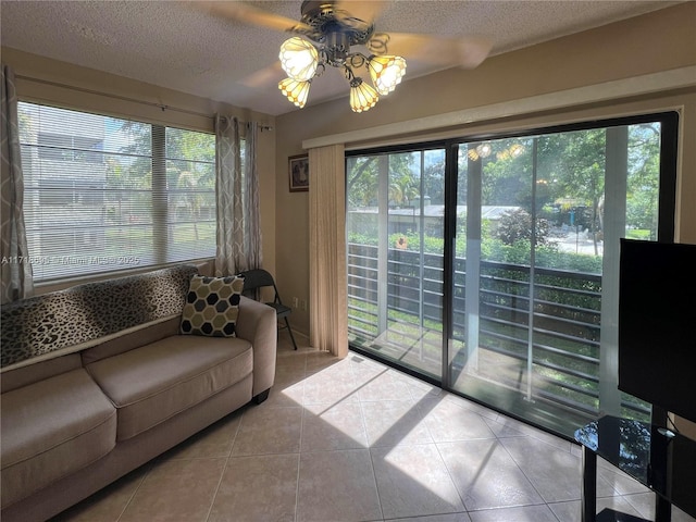 tiled living room featuring ceiling fan and a textured ceiling