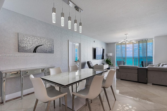 dining space with a wall of windows, a textured ceiling, and an inviting chandelier