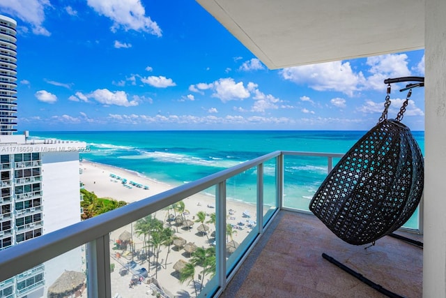 balcony with a water view and a beach view