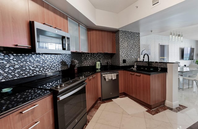 kitchen featuring appliances with stainless steel finishes, backsplash, dark stone countertops, and sink