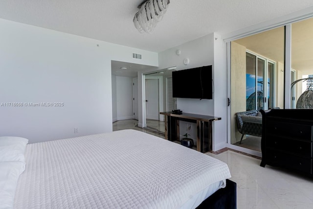 tiled bedroom with a textured ceiling