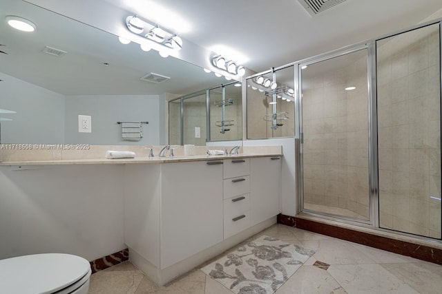 bathroom with tile patterned floors, vanity, toilet, and walk in shower