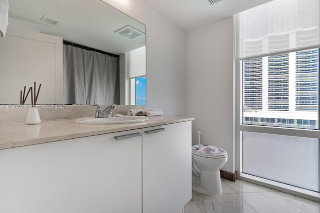 bathroom featuring vanity and toilet