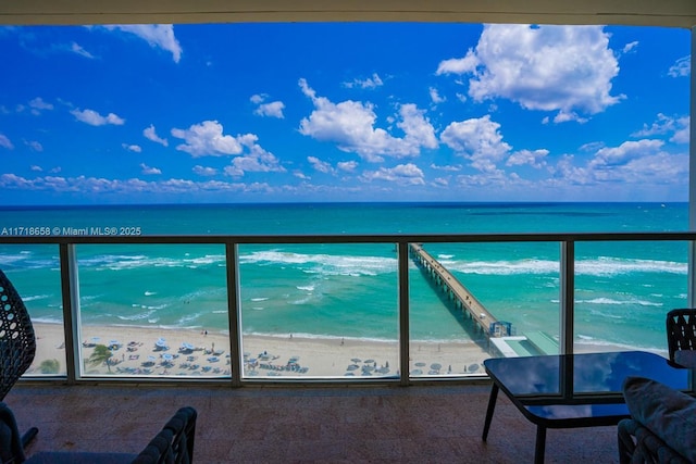 balcony with a view of the beach and a water view