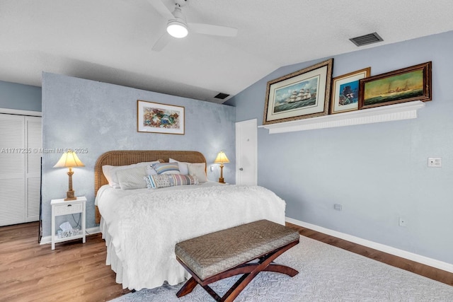 bedroom featuring wood-type flooring, a closet, ceiling fan, and lofted ceiling