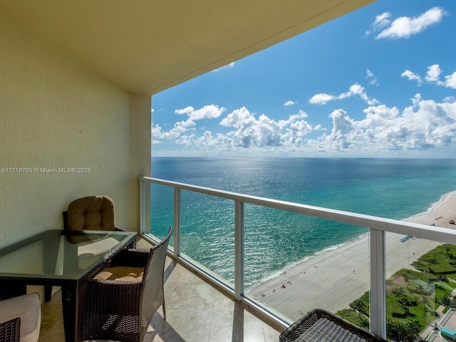 balcony with a beach view and a water view